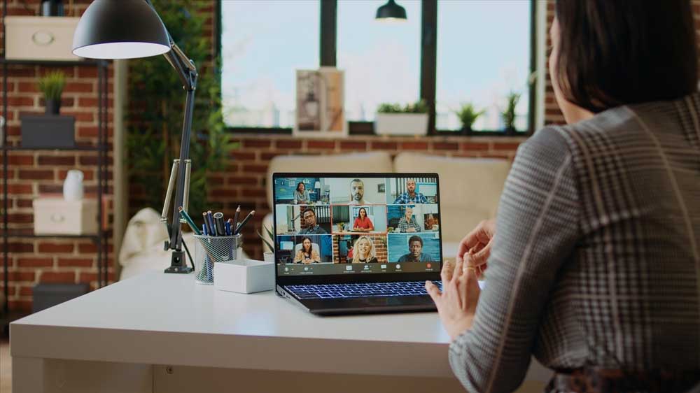 Person attending video conference on laptop